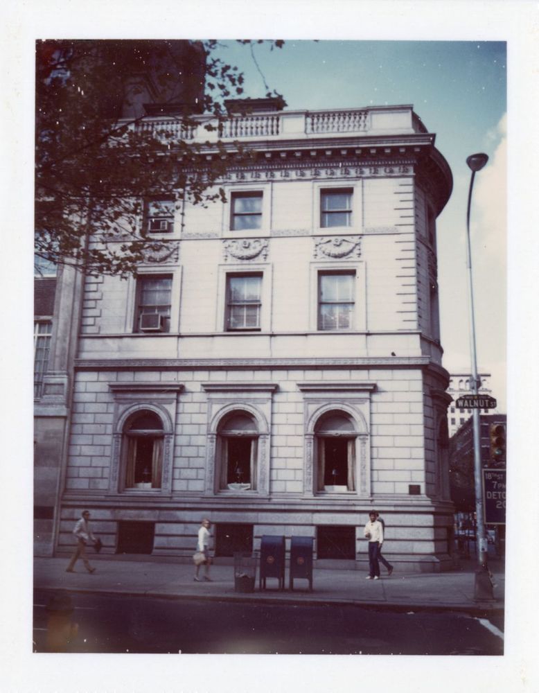 A street view of the Sarah Van Rensselaer house. There are three stories with three windows on each floor. There is a street lamp to the right of the building with a sign for Walnut street.