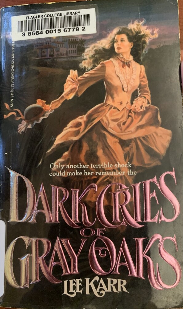 This book is titled "Dark Cries of Gray Oaks" by Lee Karr. The book cover includes a woman in period dress. She is holding her hat while she is running away. She looks off into the distance as her brown hair flies behind her. In th background, there is a white building.