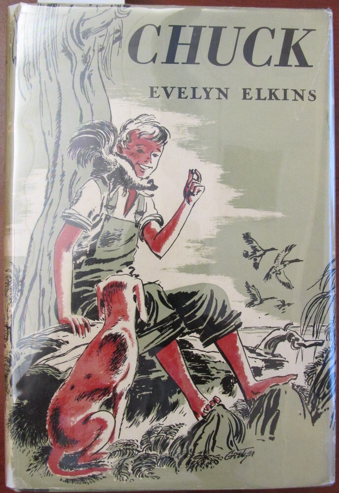 This book is titled "Chuck: A Story of the Florida Pinelands" by Evelyn Elkins. The book cover is green, black, red, and white. The illustration is of a young boy sitting on a log under a tree. He holds some sort of food in his hand while a small animal sits on his shoulder. A dog sits next to the boy.