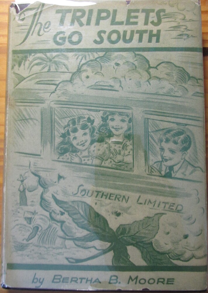 This book is titled "The Triplets Go South" by Bertha B. Moore. The cover of the book is a teal blue and white illustration of three children sitting in a train car. The two girls with bouncy curly hair and the boy with a suit and tie on are peeking out of the window. The train car has "Southern Limited" written on the side. There are palm trees in the distance.