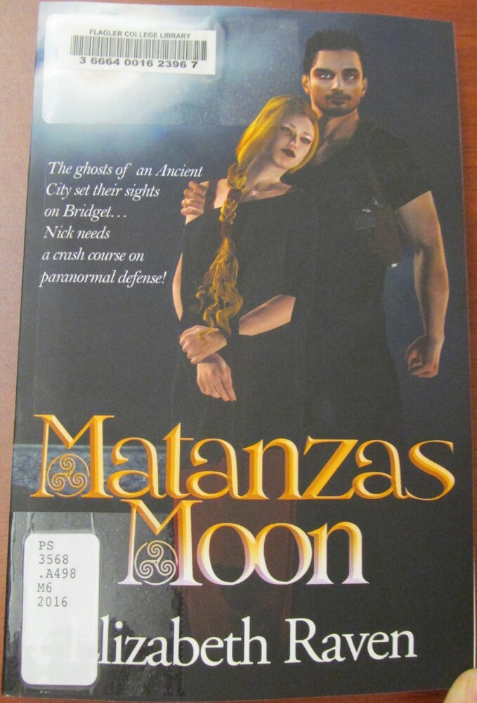 This book is titled "Matanzas Moon" by Elizabeth Raven. The cover of the book includes an illustration of two people: a woman on the left, leaning her head against the man standing next to her. The woman has a long red braid and the man puts his right hand around her shoulder. To the left of the illustration, it is written, "The ghosts of an Ancient City set their sights on Bridget... Nick needs a crash course on paranormal defense!"