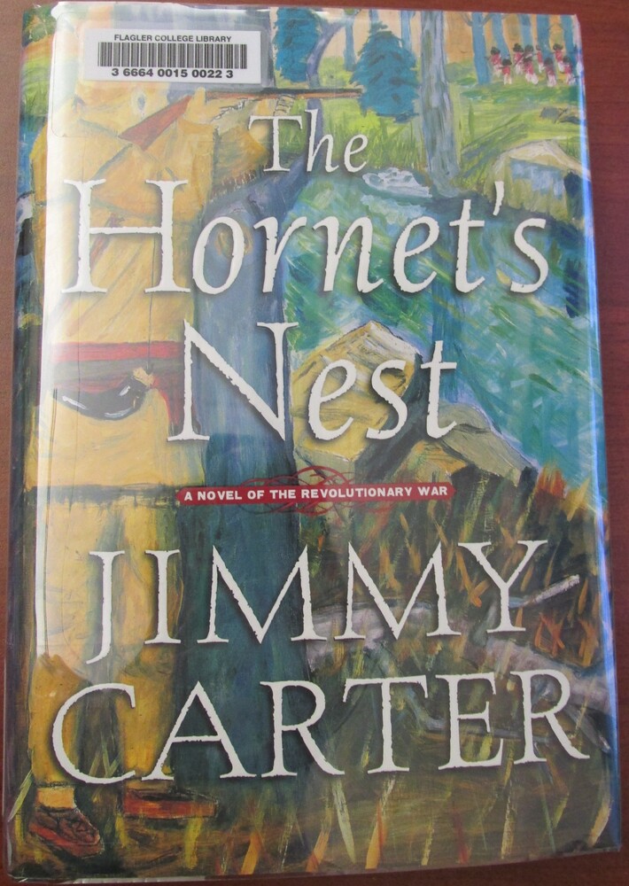This book is titled "The Hornet's Nest: A Novel of the Revolutionary War" written by Jimmy Carter. The cover of the book contains a painting of a young soldier hiding behind a tree, pointing a gun across a river towards a group of British soldiers in their redcoats.