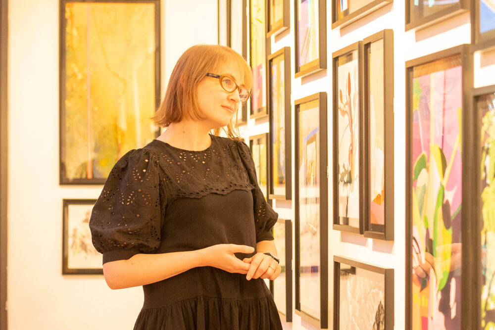 A colour photograph of a woman in a gallery